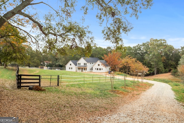 view of community featuring a yard and a rural view