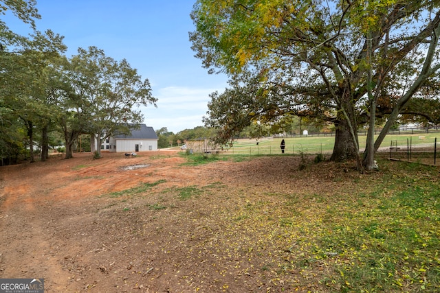 view of yard with a rural view