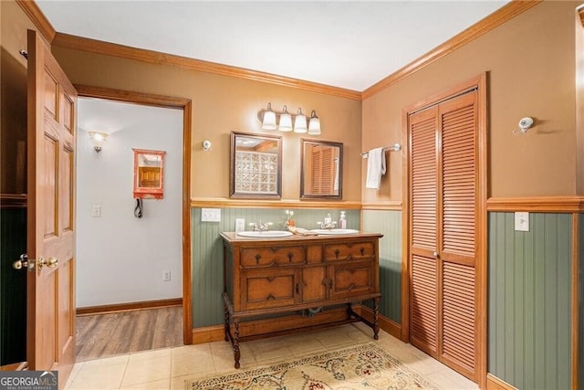 bathroom featuring vanity, tile patterned floors, and crown molding