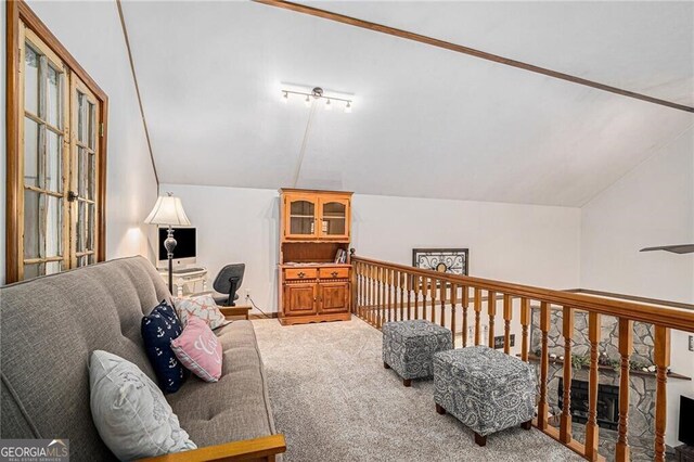 living area with carpet and lofted ceiling