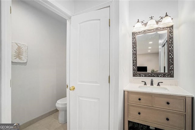 bathroom with tile patterned flooring, vanity, and toilet