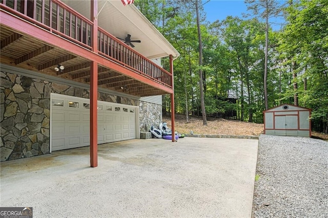 view of patio with ceiling fan, a deck, and a storage unit