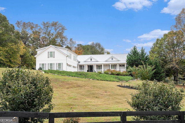 back of house with a garage, a yard, and fence