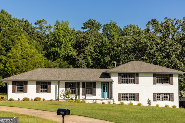 split level home with a front yard and covered porch