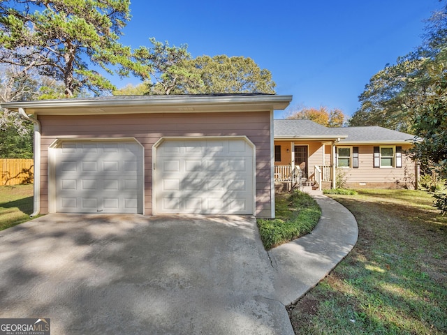 single story home featuring covered porch, a garage, and a front lawn