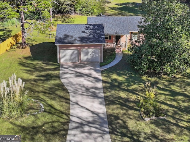 view of front of property featuring a front yard and a garage