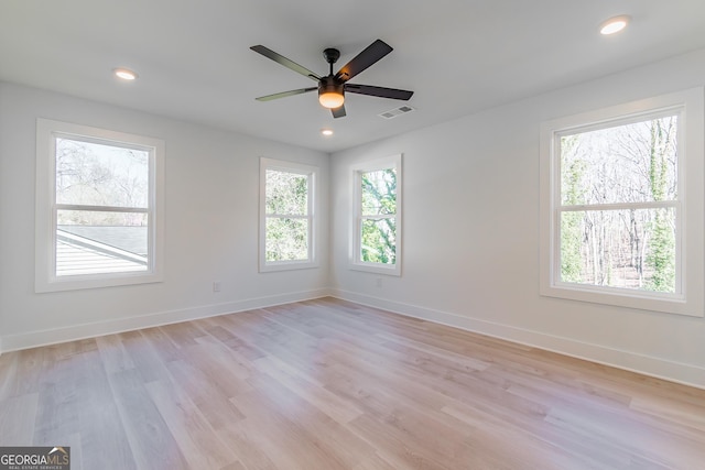 unfurnished room with ceiling fan and light hardwood / wood-style floors