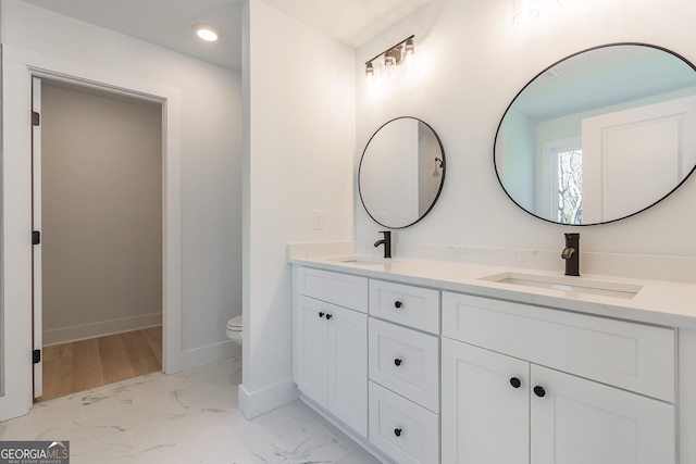 bathroom featuring vanity and toilet