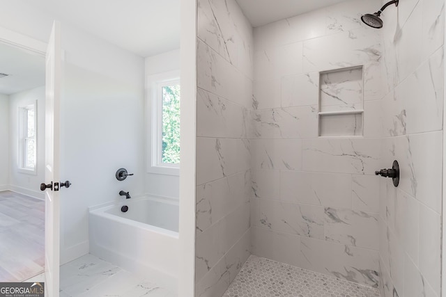 bathroom featuring shower with separate bathtub