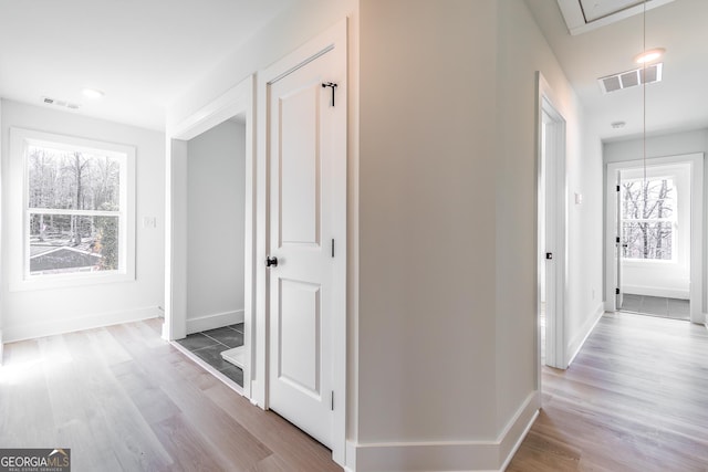 hallway with hardwood / wood-style floors