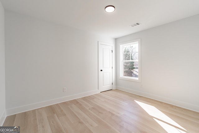 spare room featuring light wood-type flooring