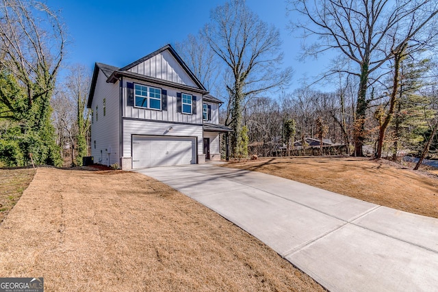 view of property featuring a garage and a front lawn