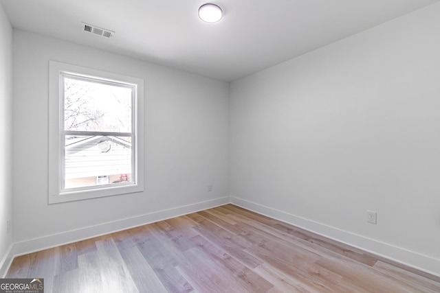 spare room featuring light wood-type flooring