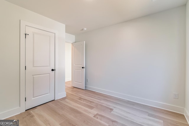 unfurnished bedroom with light wood-type flooring