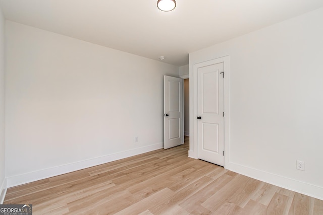 unfurnished room with light wood-type flooring