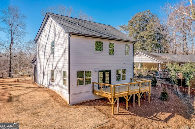 back of property with a wooden deck