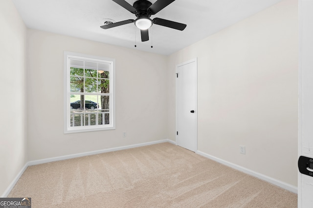 unfurnished room featuring ceiling fan and carpet floors