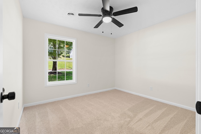 empty room featuring ceiling fan and carpet floors