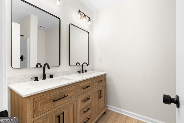 bathroom featuring vanity and hardwood / wood-style flooring