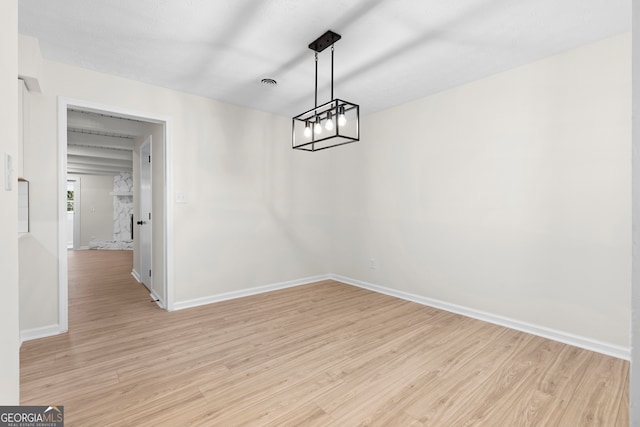 unfurnished dining area featuring light wood-type flooring