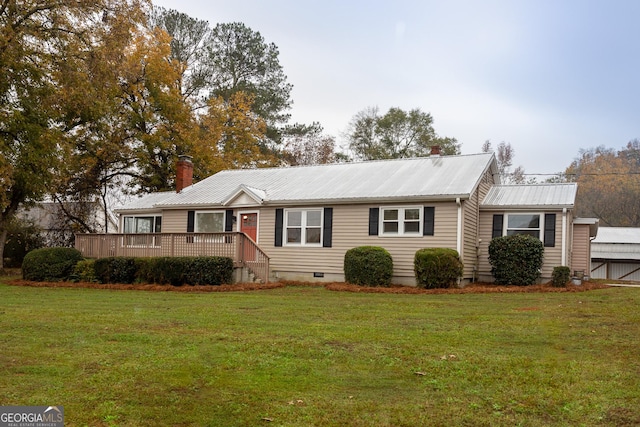 ranch-style home with a front yard and a deck