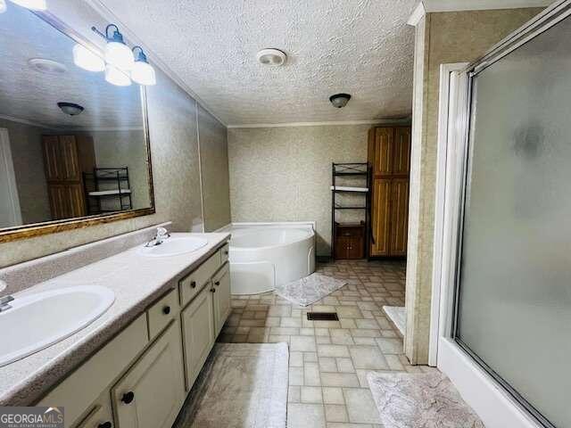 bathroom with vanity, independent shower and bath, and a textured ceiling