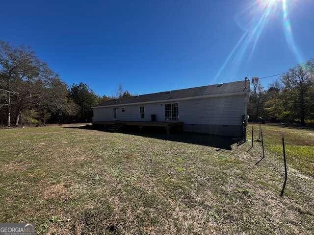 rear view of property with a yard