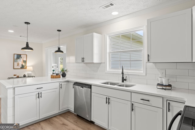 kitchen with stainless steel dishwasher, a textured ceiling, sink, pendant lighting, and white cabinetry