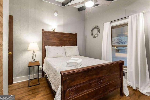 bedroom with dark hardwood / wood-style floors and ceiling fan