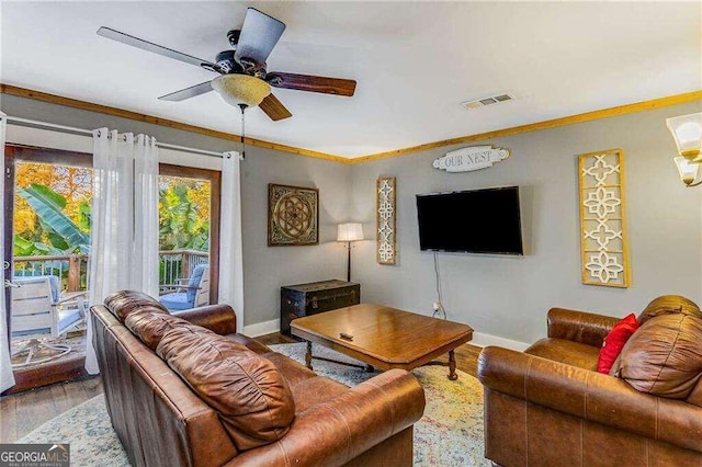 living room featuring crown molding, hardwood / wood-style floors, and ceiling fan