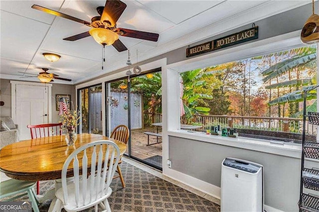 dining space with a wealth of natural light, crown molding, and ceiling fan