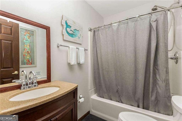 full bathroom featuring shower / bath combination with curtain, vanity, and toilet