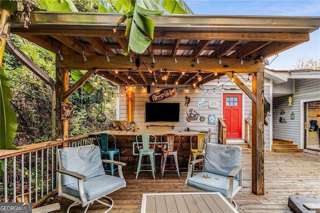 wooden terrace featuring a bar