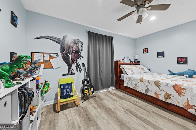 bedroom featuring ceiling fan and light wood-type flooring