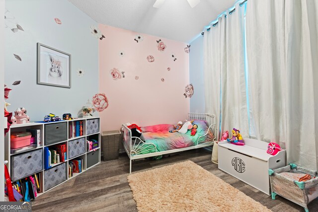 bedroom with a textured ceiling, ceiling fan, vaulted ceiling, and dark hardwood / wood-style floors