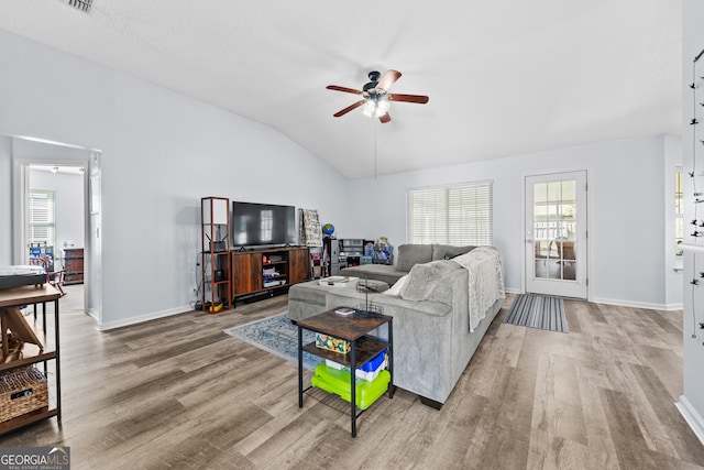 living room featuring hardwood / wood-style floors, ceiling fan, and lofted ceiling