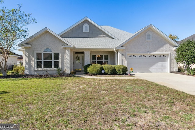 view of front of home with a garage and a front lawn