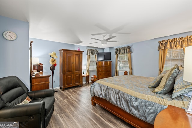 bedroom with ceiling fan and dark hardwood / wood-style flooring