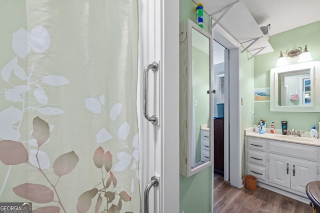 bathroom with vanity and wood-type flooring