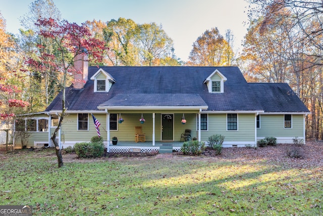 cape cod-style house with a front yard and a porch