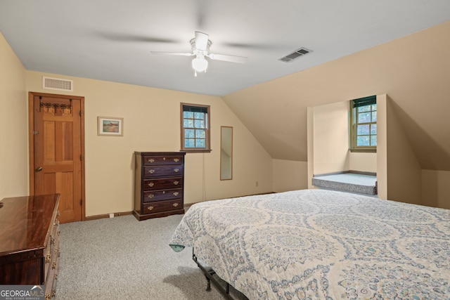 carpeted bedroom with ceiling fan and lofted ceiling