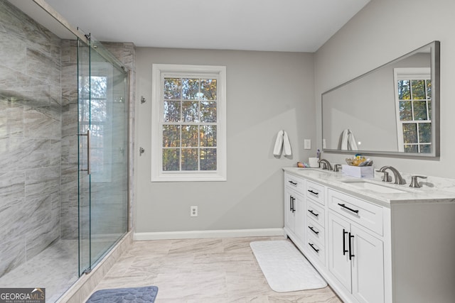 bathroom with vanity, walk in shower, and a healthy amount of sunlight