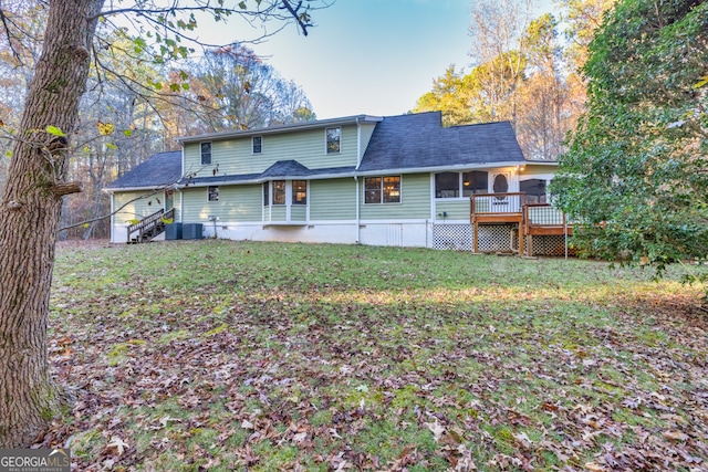 back of house with a lawn, central AC unit, and a deck