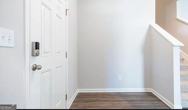 interior space with stairway, wood finished floors, and baseboards