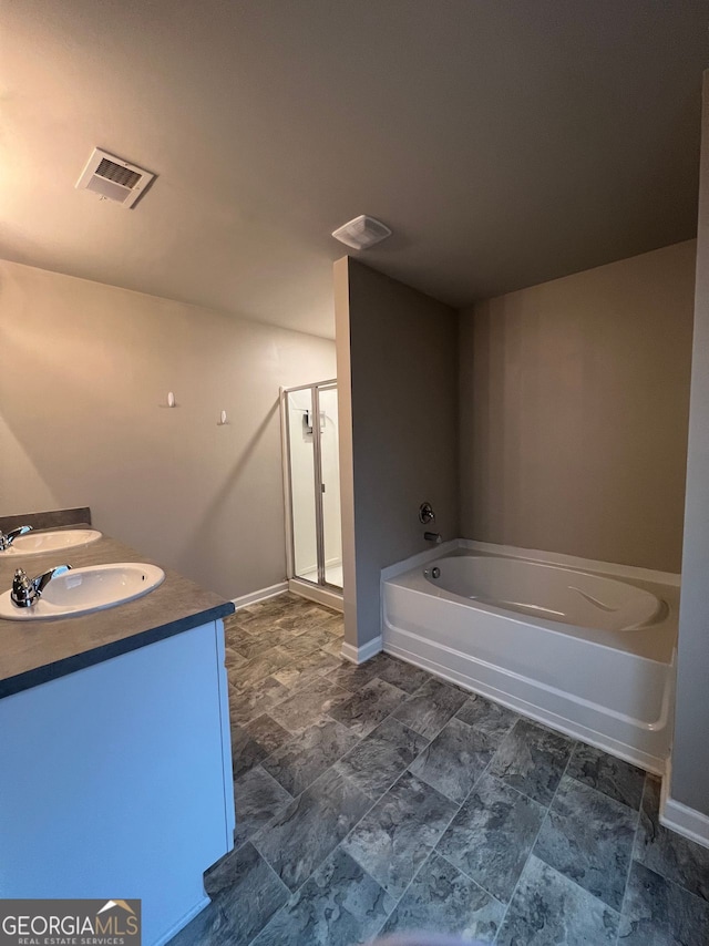 full bath featuring a stall shower, visible vents, a sink, and a garden tub