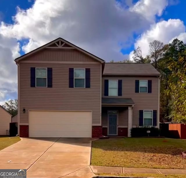 view of front of house featuring an attached garage, driveway, brick siding, and a front yard