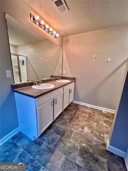 bathroom with a sink and baseboards