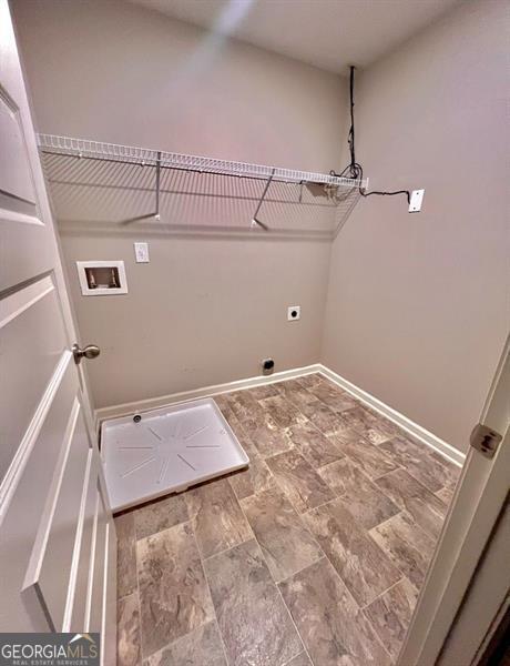 clothes washing area featuring baseboards, laundry area, washer hookup, and hookup for an electric dryer