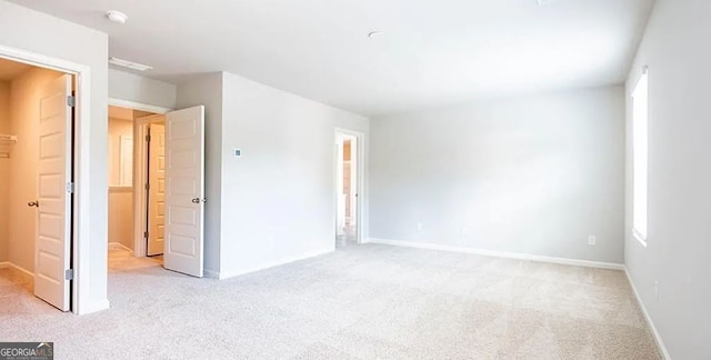 unfurnished bedroom with carpet and baseboards