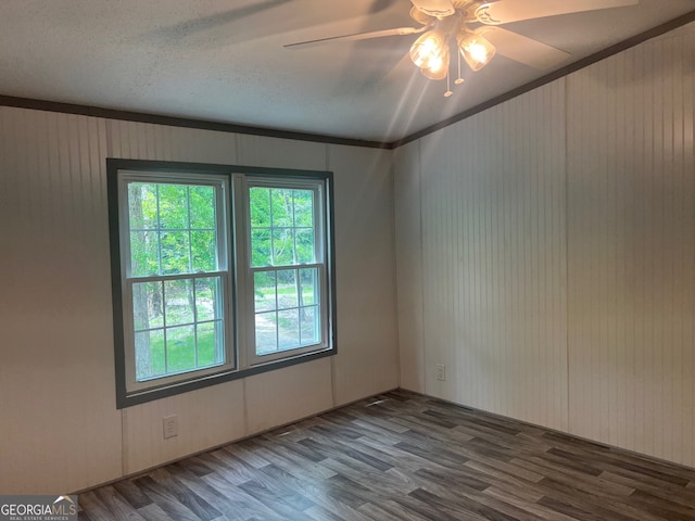 spare room with wood-type flooring, ceiling fan, and crown molding